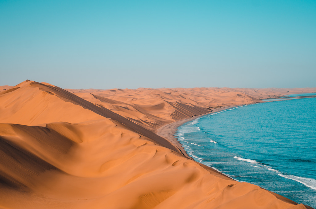 quotes about desert sand dunes along a coastline with blue water