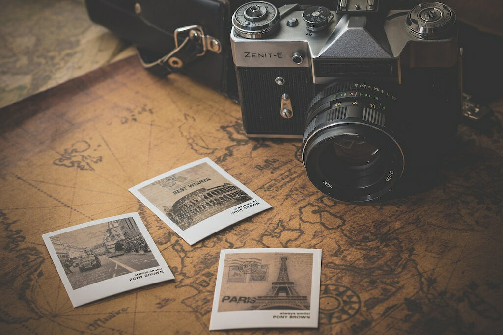vintage camera and polaroid photos on a map puns