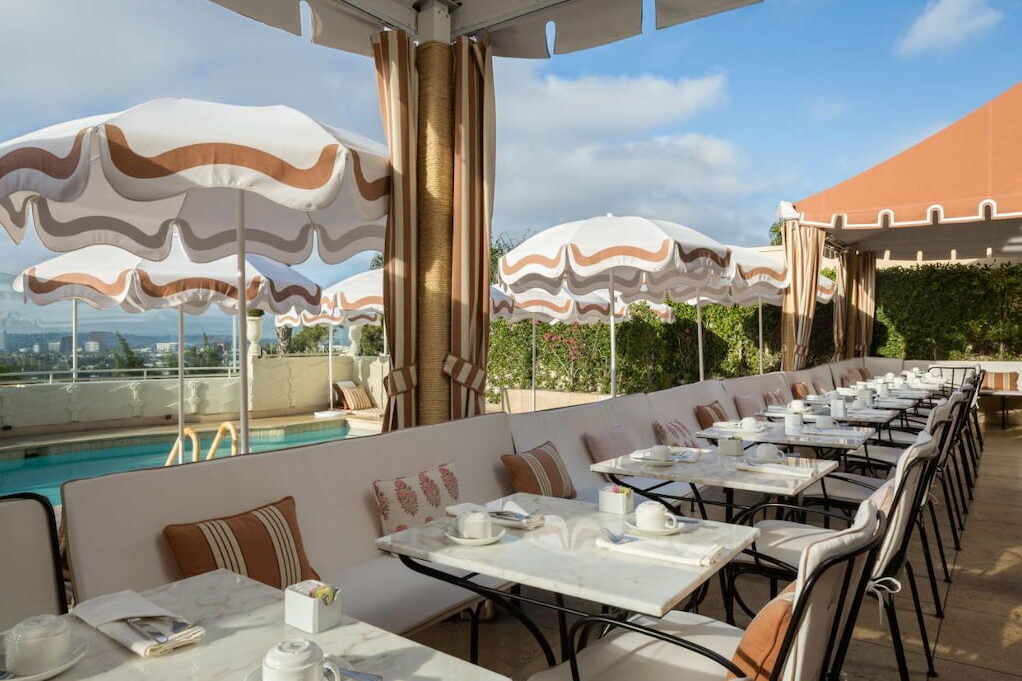 An outdoor restaurant near the pool beside the umbrellas.