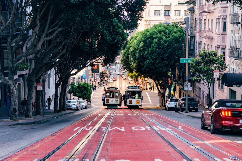 two cable cars on a red road in San Francisco California