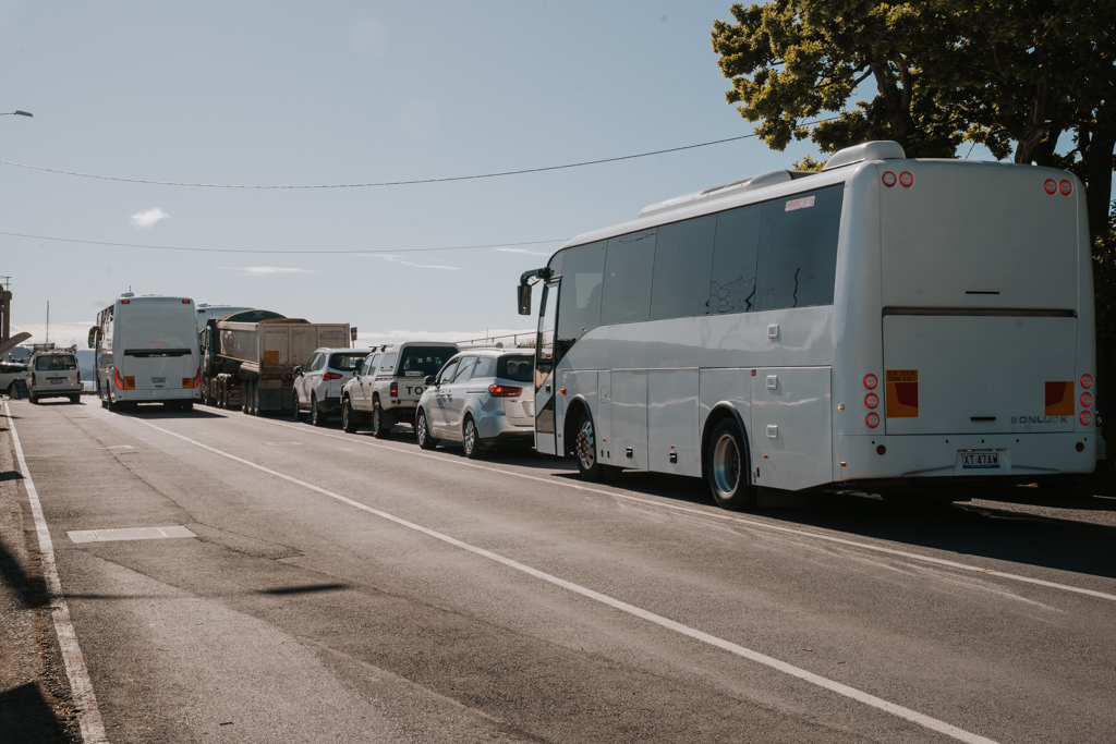 large white busses and small rental cars in Tasmania wait at the Kettering port for the best ferry to Bruny Island Tasmania