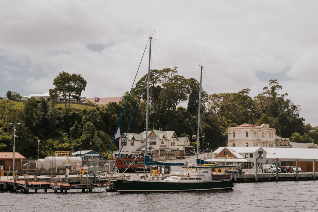 harbour view of historical downtown of Strahan with sailboat in the foreground