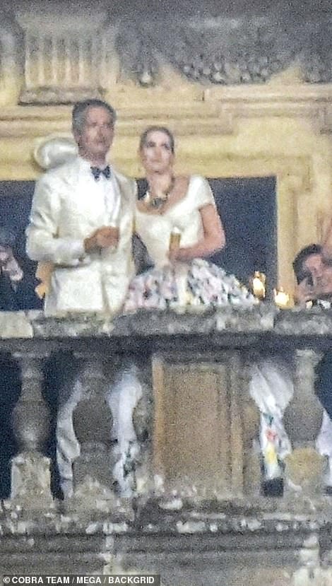 The couple had their arms around one another as they enjoyed their champagne toast after their nuptials last night