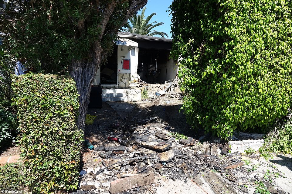 The apartment complex with adjoining garage is pictured following the crash on Friday morning in Los Angeles