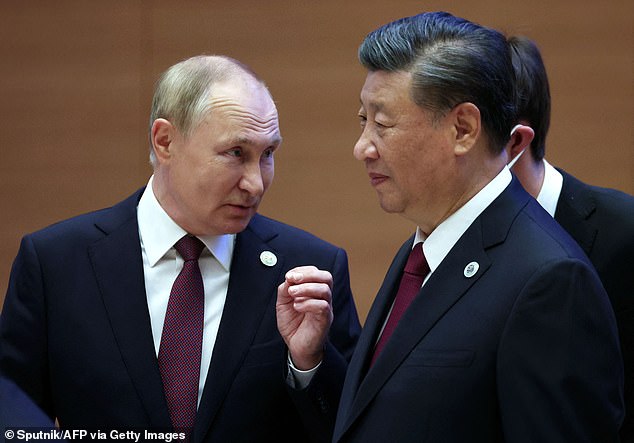 Putin (left) acknowledged China's unspecified 'questions and concerns' about the war in Ukraine while also thanking Chinese President Xi Jinping (right) for his government's 'balanced position' on the conflict