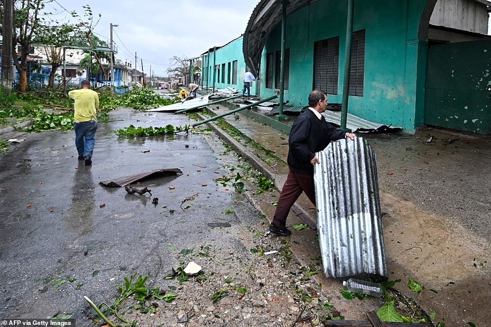 People are seen on a street in Consolacion del Sur, Cuba, during the passage of the storm - Hurricane Ian made landfall in western Cuba early Tuesday