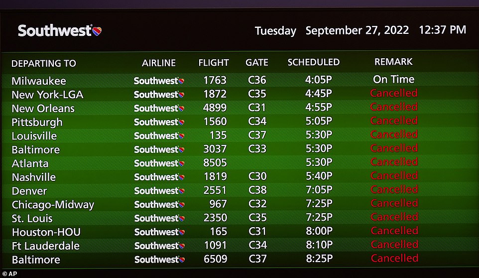 Canceled flights are shown on a video board at the Southwest Airlines ticket counter at the Tampa International Airport on Tuesday