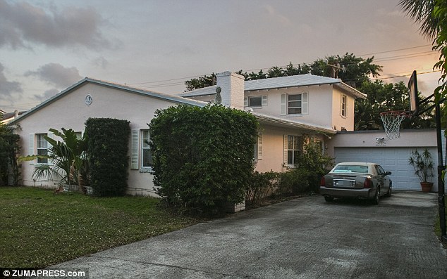 Bloody scene: The Florida home where Jennifer Berman, Alexander Berman and Jacqueline Berman were found dead on January 13 in West Palm Beach by their horrified father. The five-bedroom home was in the process of being sold for $590,000 - but court records show there were two mortgages on the home totaling almost $700,000.