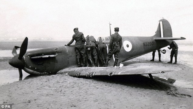 German soldiers inspect Stephenson's Supermarine Spitfire MK1 N3200 after it was shot down on a beach at Sangatte, near Calais on May 26, 1940. The British airman was captured and spent time as a POW at Colditz