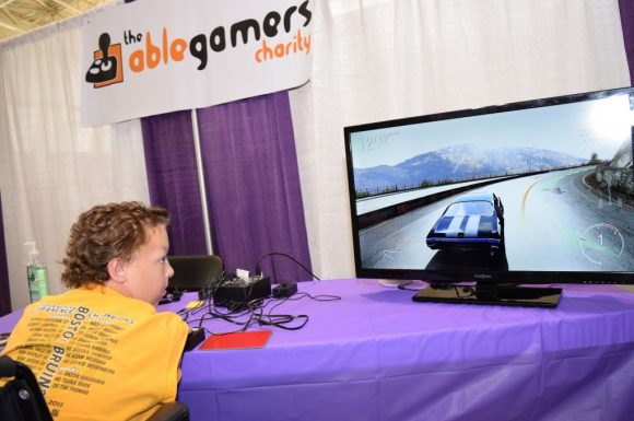 Boy with no arms playing a racing game