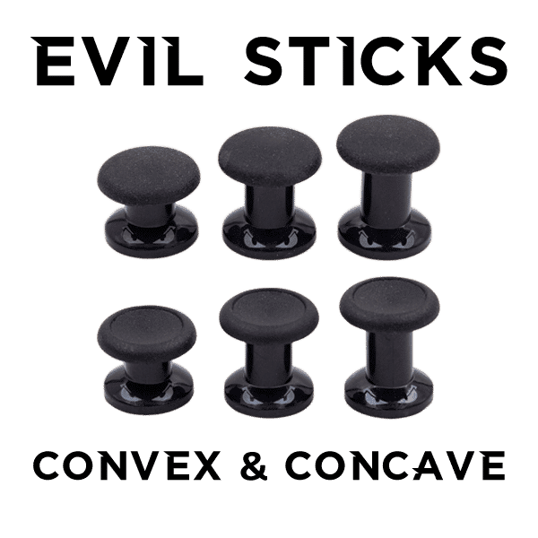 Two small, black thumb sticks, two medium-sized, black thumb sticks, and two tall, black thumb sticks. The words "Evil Sticks" is printed above, and "Convex & Concave" are printed below.