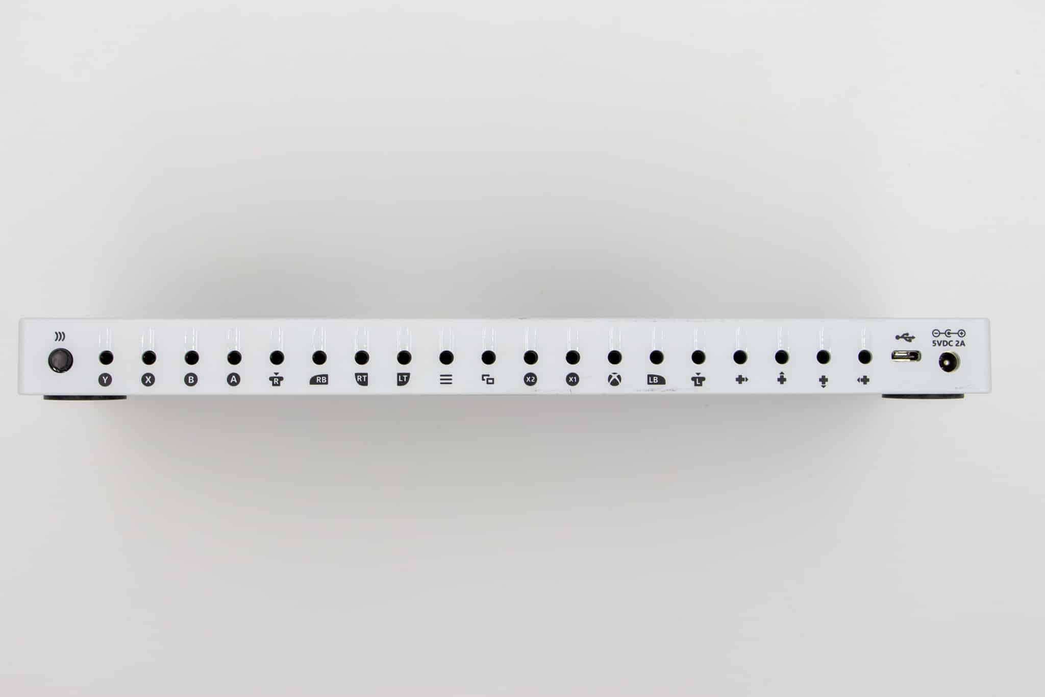 The various ports on the back of an Xbox Adaptive Controller. There are icons below each port indicating what input it represents.