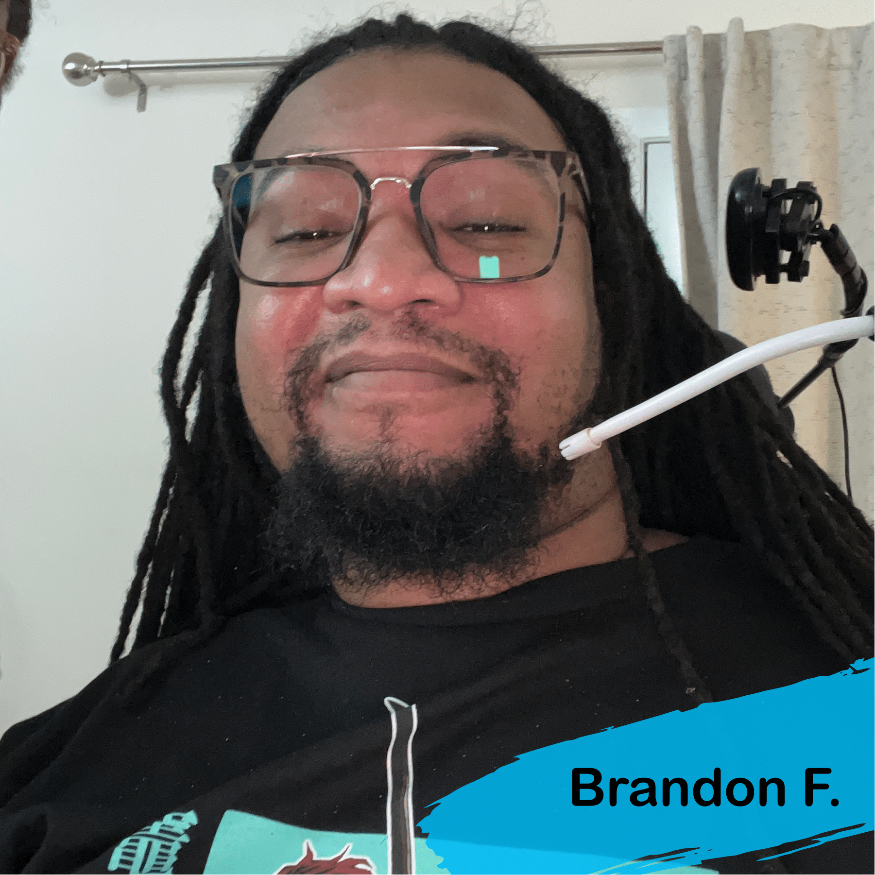 A photo of Brandon, a young man, he has black hair and a beard and he is wearing glasses