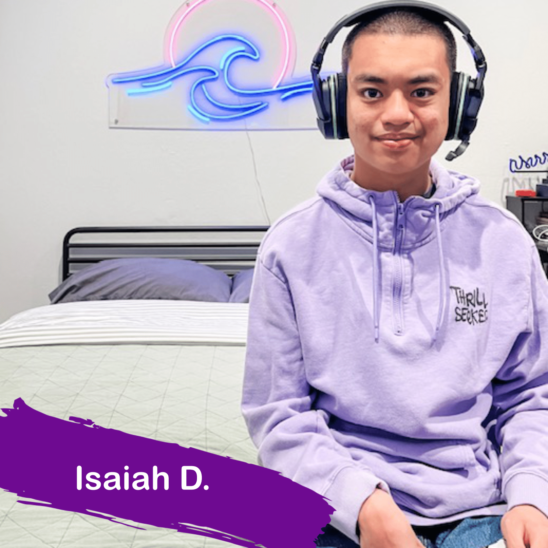 A photo of Isaiah he is wearing a purple hoodie and black headphones after working with AbleGamers to find the right adaptive gaming controller