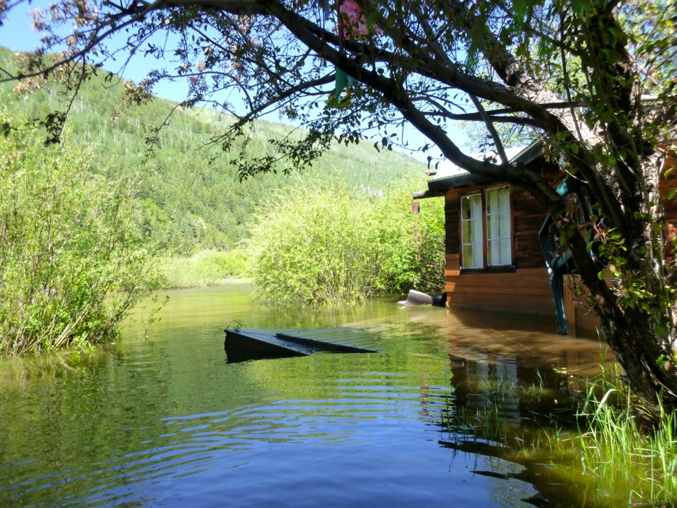 A cabin dating to the mid-1960s in the Stillwater section of the Roaring Fork River was flooded in June 2015, with standing water in the living room and in a nearby art studio.