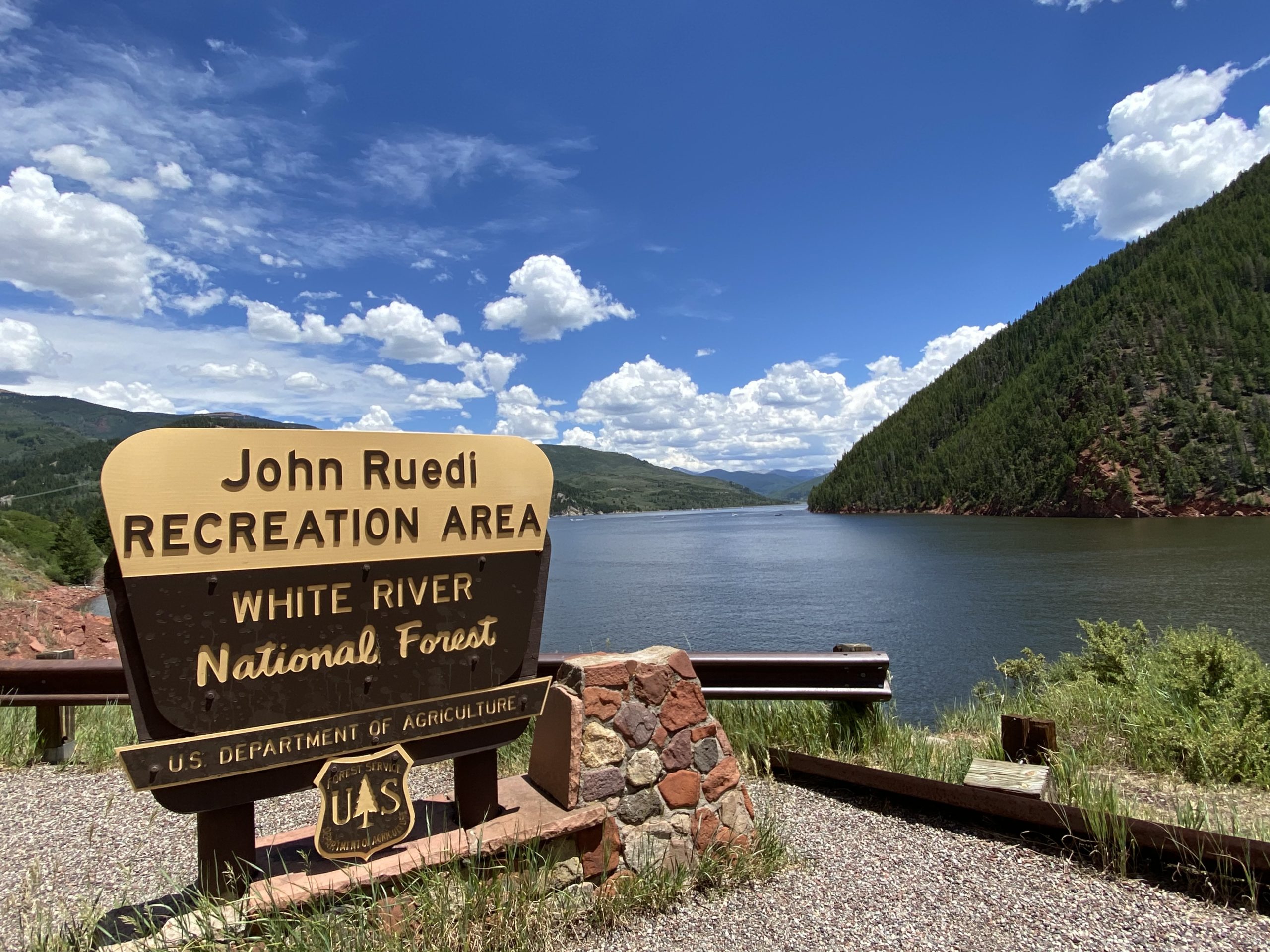 Ruedi reservoir with sign saying "John Ruedi Recreation Area White River National Forest"