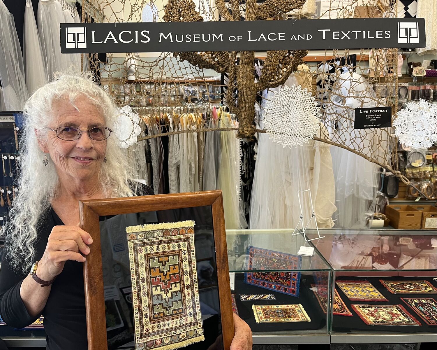 Toby St John displays her miniature rugs at Lacis Museum