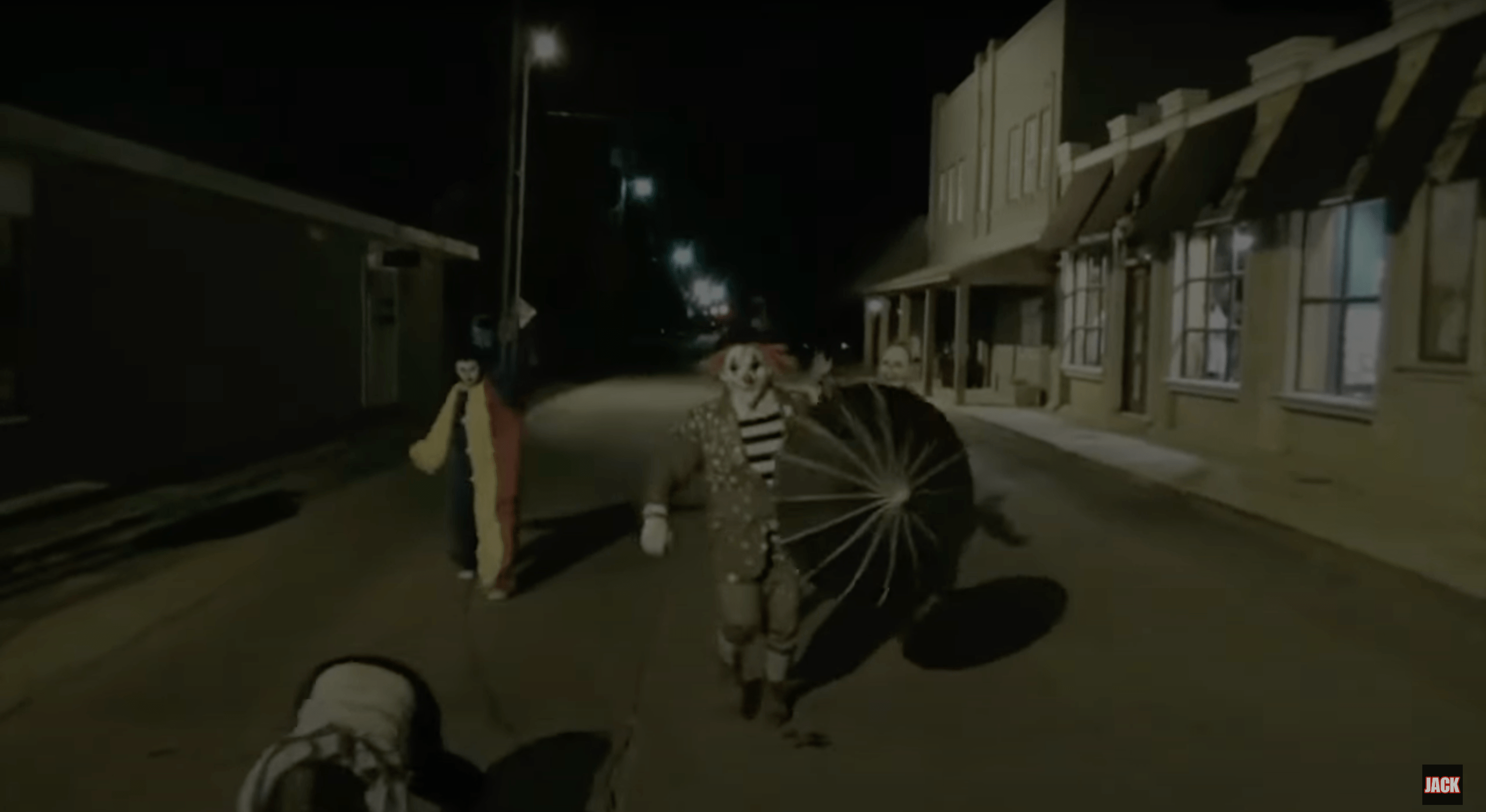 A trio of clowns walk down an alley on security cam footage