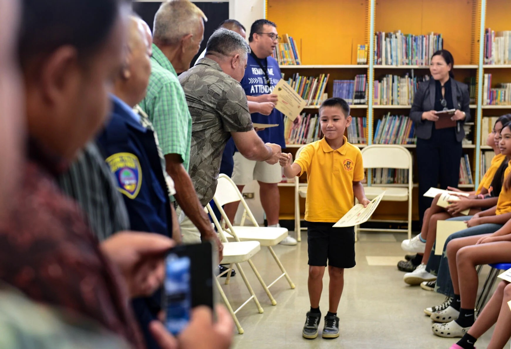 Talofofo Elementary School 5th-grader Greyson Williams-Materne gets a congratulatory fist-pound from Sen. Chris Barnett during a May 7, 2024, commencement ceremony held for students who successfully completed the Guam Police Department’s Drug Abuse Resistance Education, DARE, “Keeping it Real” [sic] program curriculum. The pilot program, offered by the Guam Department of Education and GPD’s Auxiliary Services Division, helps educate students to make safe and responsible choices, especially when encountering decisions relating to the temptations of drugs, resisting peer pressure and stress management. Rick Cruz/Pacific Daily News