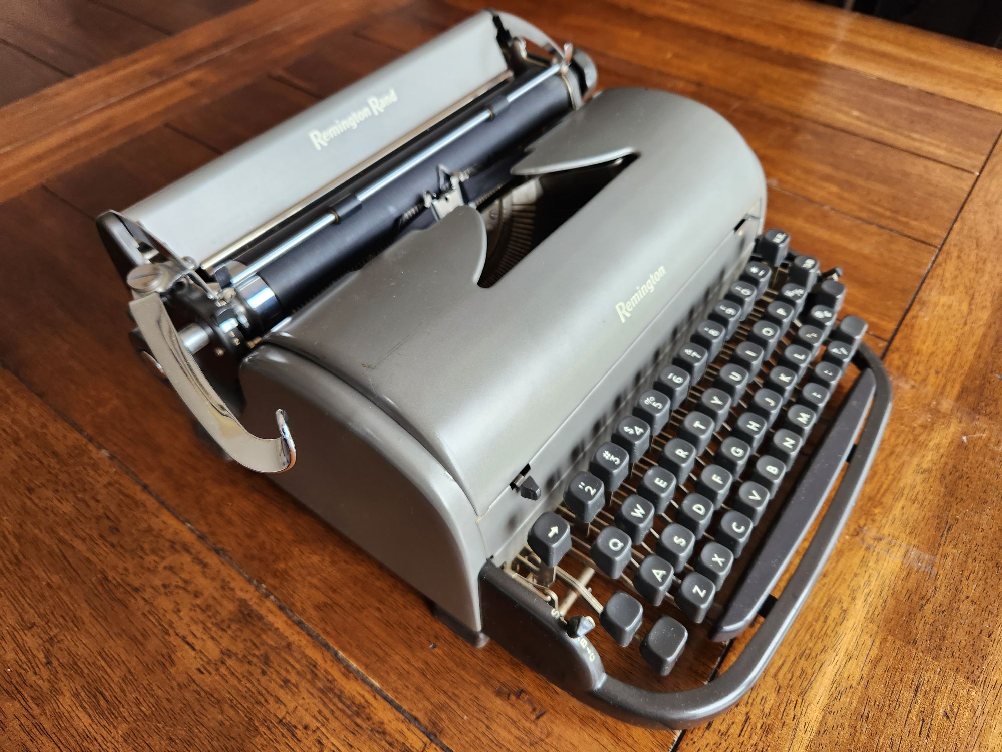 Angle from the front left down onto a gunmetal gray Remington All-New typewriter