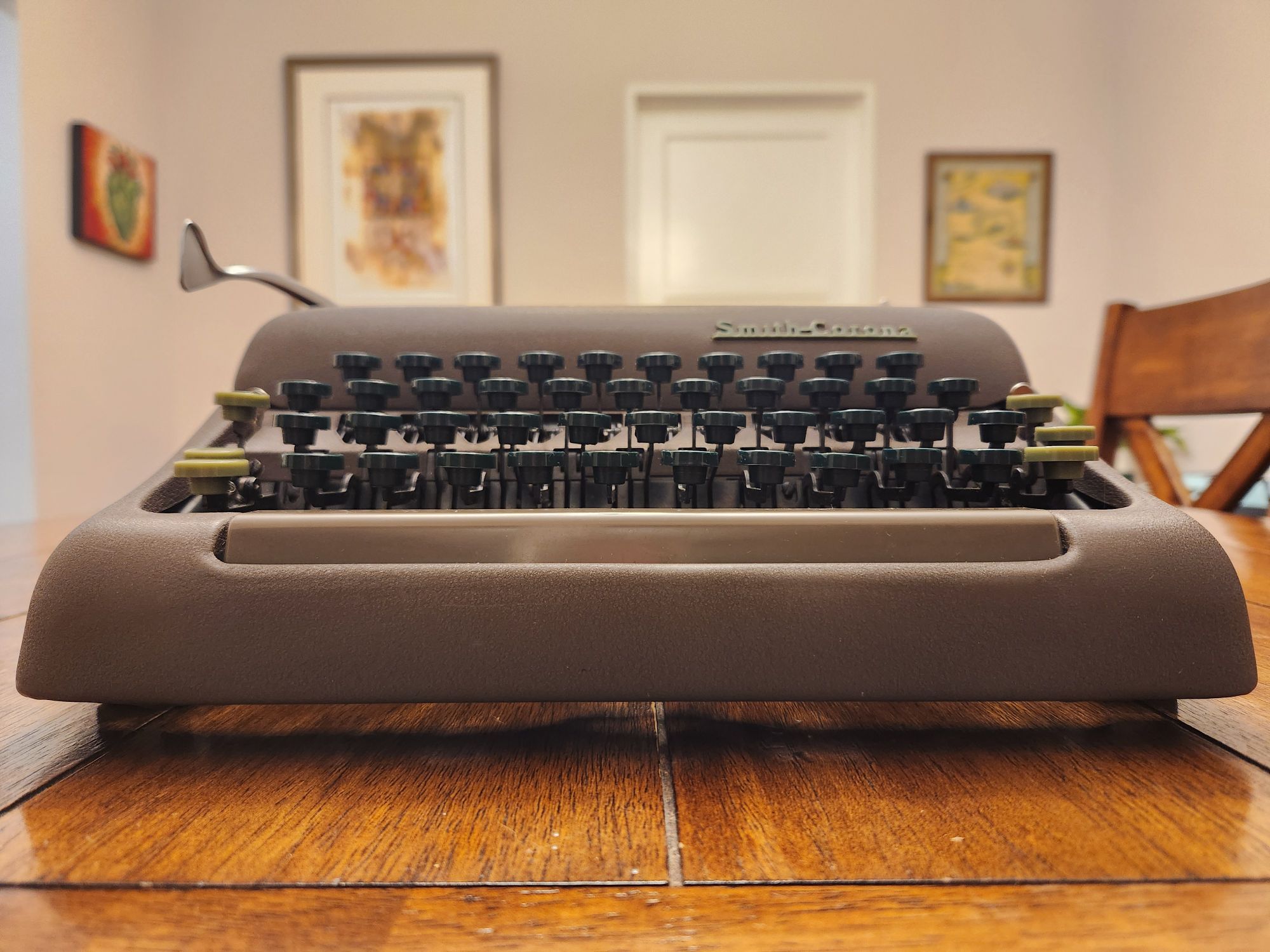 Table level view of the 1953 Smith-Corona Silent  with the light keys focused on in the front.