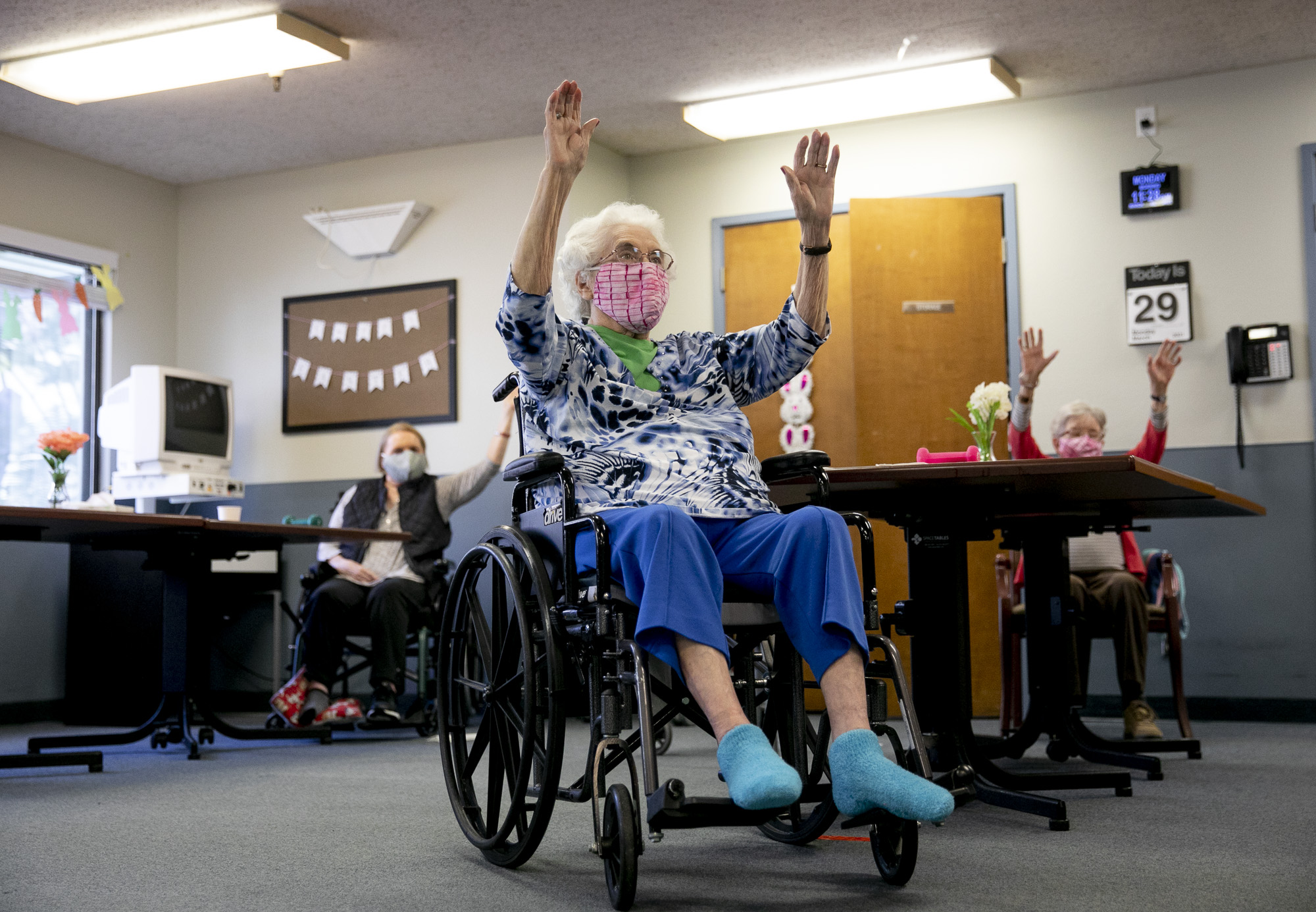 Betty Carter, center, participates in group exercise during an activity period with others from her cohort at Lincoln Glen Skilled Nursing Facility in San Jose on March 29, 2021. Photo by Anne Wernikoff, CalMatters