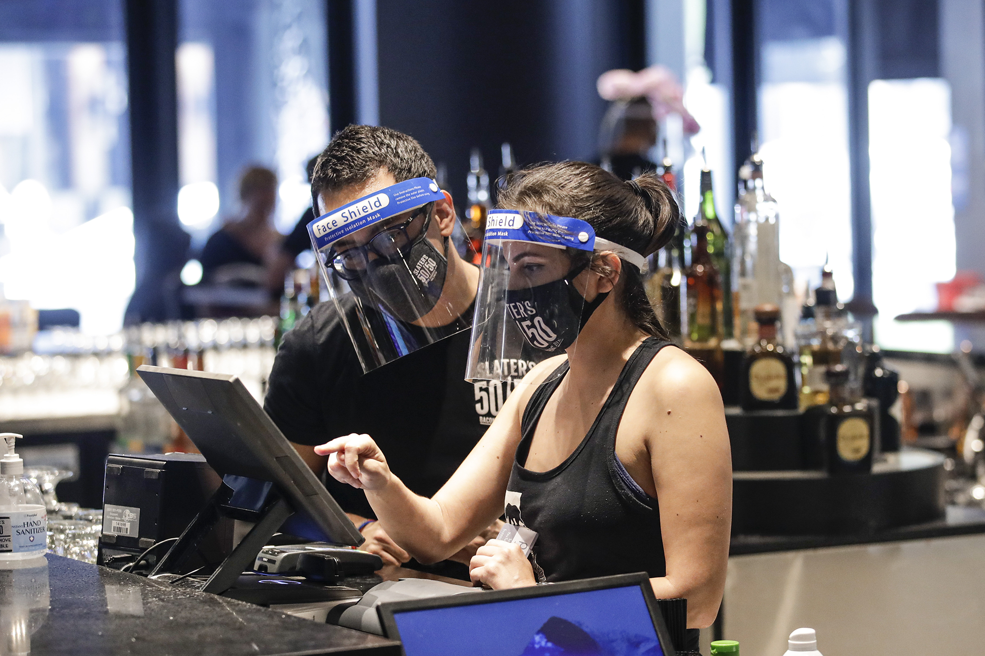 Bartenders were masks and face shields as they work at Slater's 50|50 on July 1, 2020, in Santa Clarita. Photo by /Marcio Jose Sanchez, AP Photo