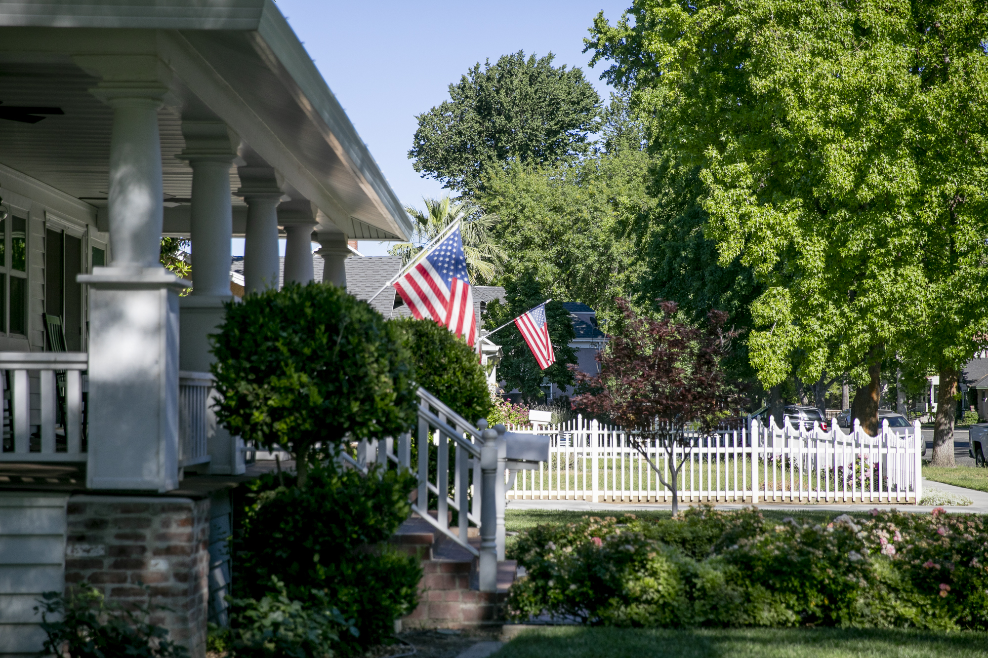 American flags hang from many of the homes in Colusa on May 25, 2021. Photo by Anne Wernikoff, CalMatters