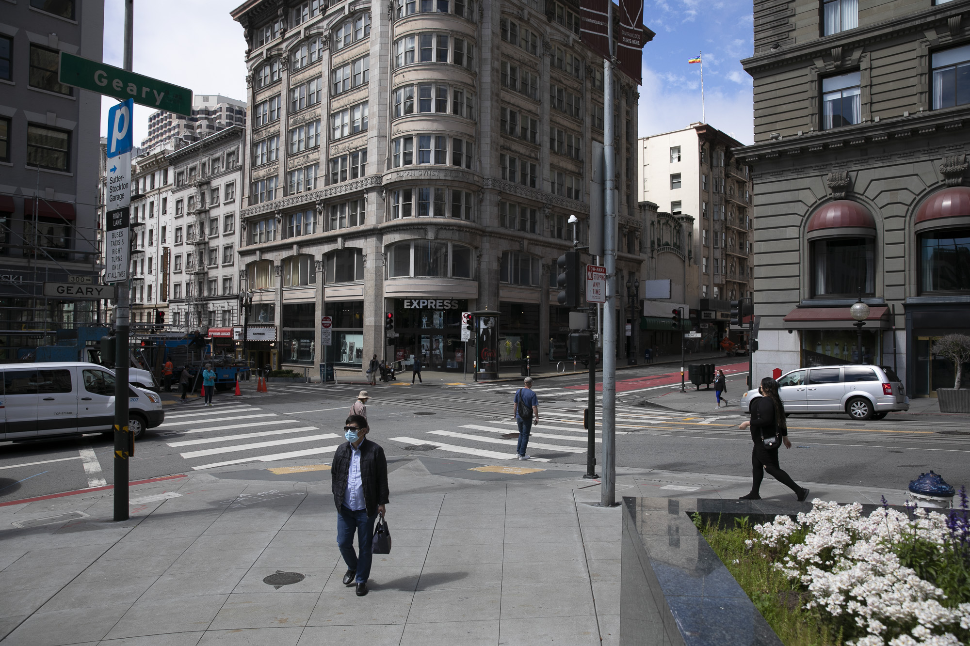 Pedestrians walk through union square in San Francisco on June 14, 2021. The intersection of Geary and Powell Streets would have been busy with traffic, street cars and throngs of foot traffic before the pandemic. Photo by Anne Wernikoff, CalMatters