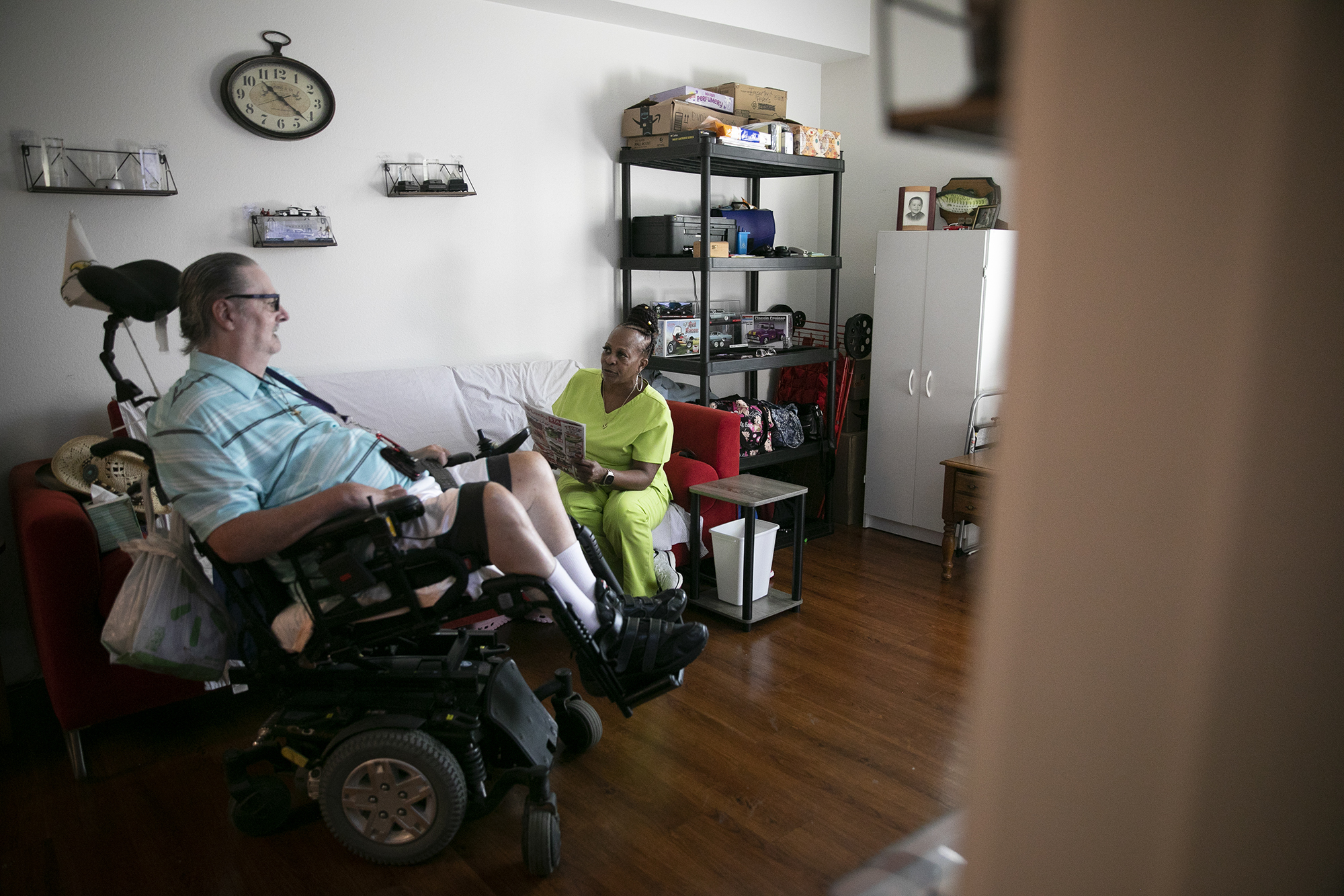 Bradley Fisher watches television with his caretaker, Carol Small, at his Antioch apartment nearly a decade after leaving the nursing home where he had lived for 14 years. Sept. 2, 2021. Photo by Anne Wernikoff, CalMatters