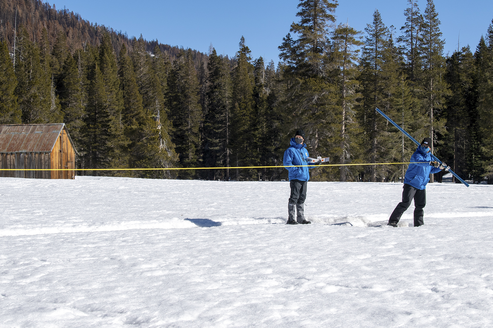 From left, Andy Reising, Water Resources Engineers in the Snow Surveys and Water Supply Forecasting Unit and Sean de Guzman, Manager of the California Department of Water Resources Snow Surveys and Water Supply Forecasting Unit, conduct the second media snow survey of the 2022 season at Phillips Station in the Sierra Nevada Mountains on Feb. 1, 2022. Kelly M. Grow/California Department of Water Resources
