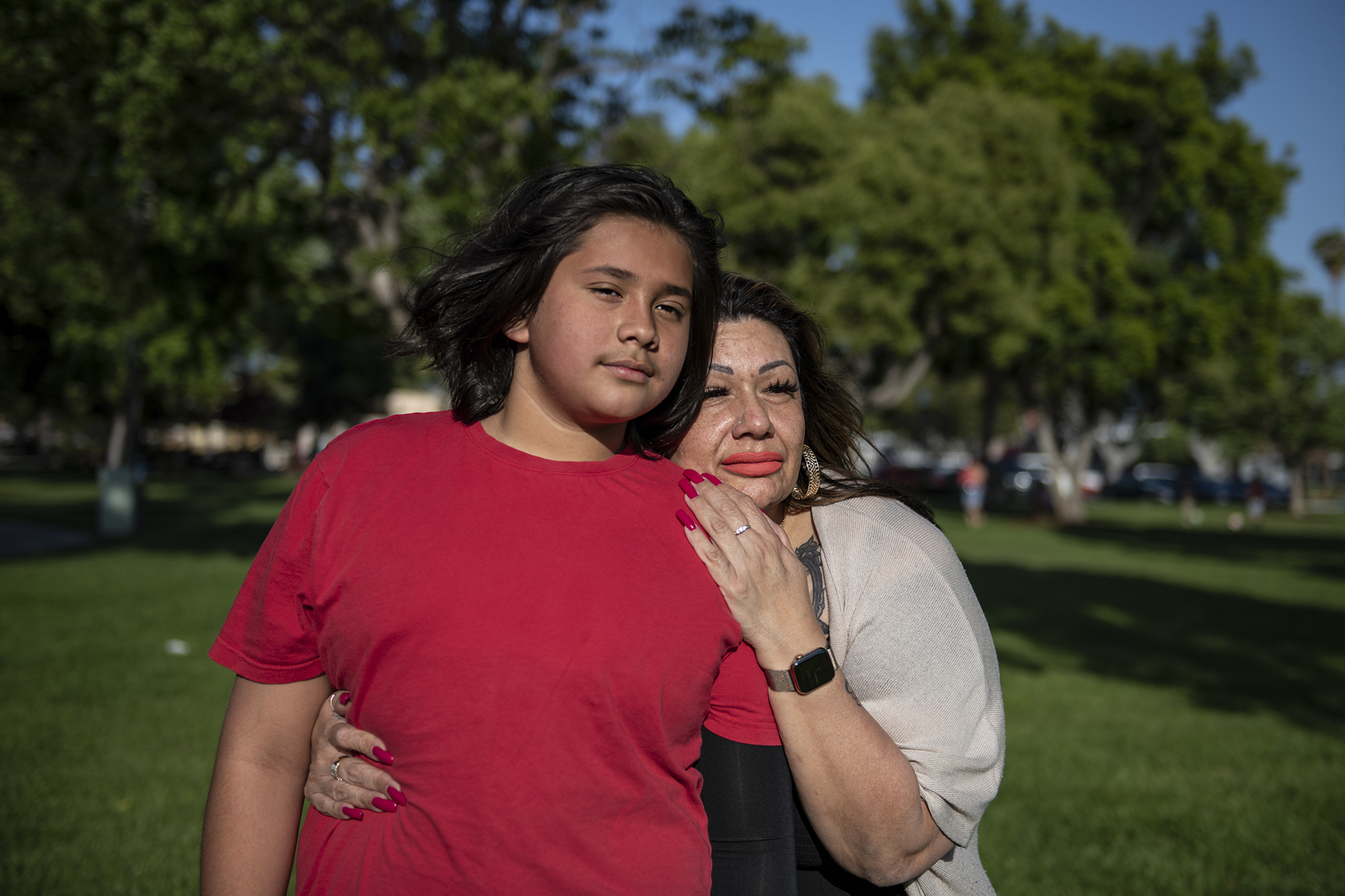 April Acosta embraces her son, Giovanny Hernandez, at Morgan Park in Baldwin Park on April 25, 2022. "There are obstacles being a student because I am a mom," Acosta, the mother of two, said. "Financially, it is not easy, but it is doable." Photo by Pablo Unzueta for CalMatters
