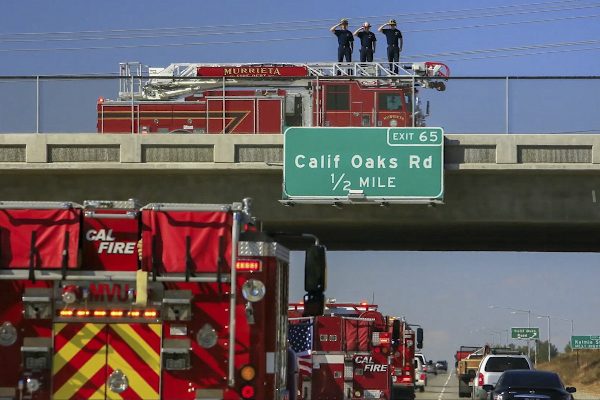 Firefighters saluted as engines escorted the body of their colleague, Ryan Mitchell. (Screenshot via YouTube)