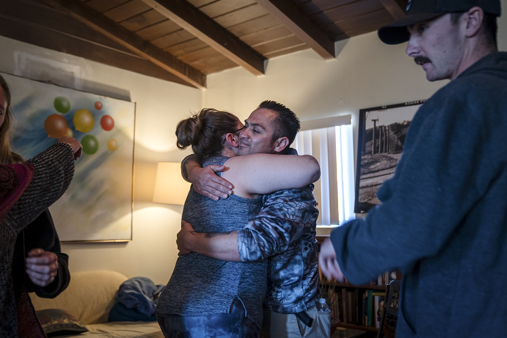 Dispatcher, Ali Wiseman and Fire Captain Hiram Vazquez embrace during a healing retreat at the Nurturing Nest in Desert Hot Spring on February 25, 2022. Photo by Ariana Drehsler for CalMatters