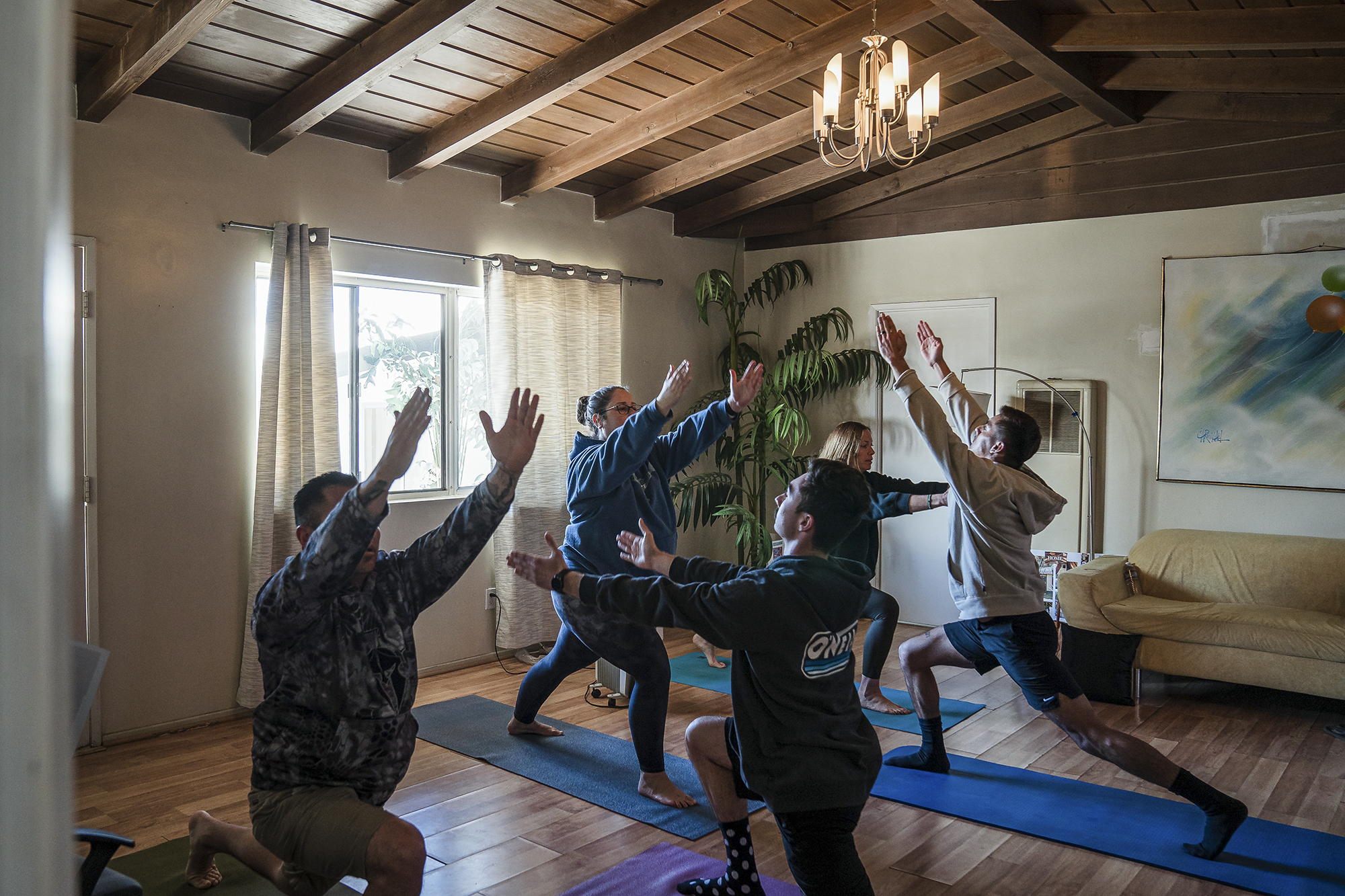 Cal Fire participants practice yoga during a healing retreat at the Nurturing Nest in Desert Hot Springs on February 25, 2022. Photo by Ariana Drehsler for CalMatters