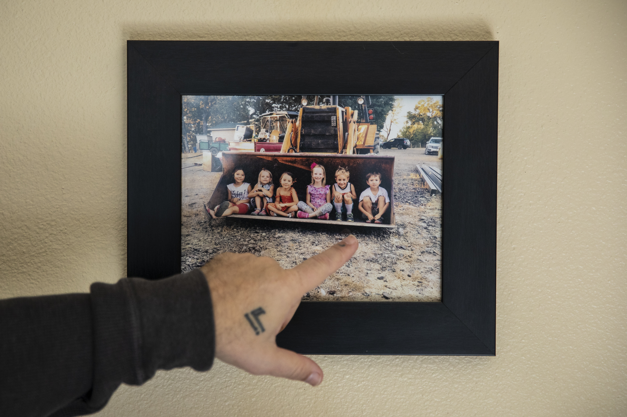 Gabriel Ferreira points to his and Ya Reinier's son, Oscar (right), in a photo on the wall in their home in Eureka on Feb. 9 2023.