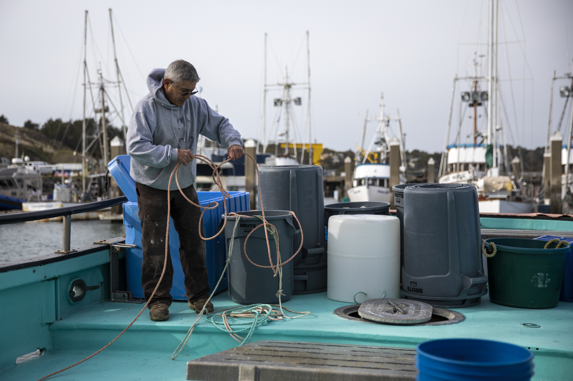Fisherman Dick Ogg coils rope aboard his boat, the Karen Jeanne, in Bodega Bay on March 3, 2023. 