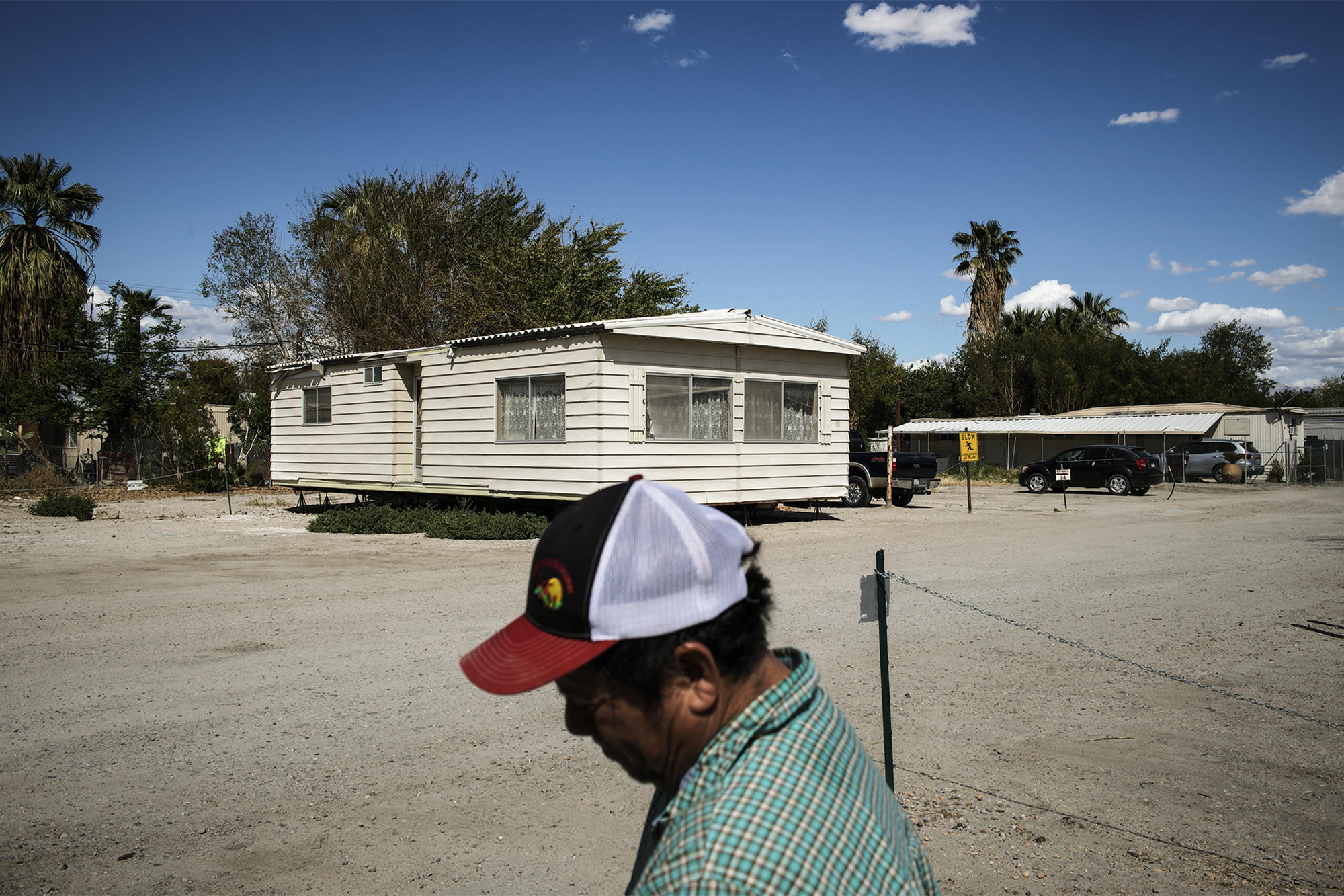 Mario Salinas, 50, is backdropped by an abandoned trailer in the Shady Lane Estates mobile home community in unincorporated Thermal 