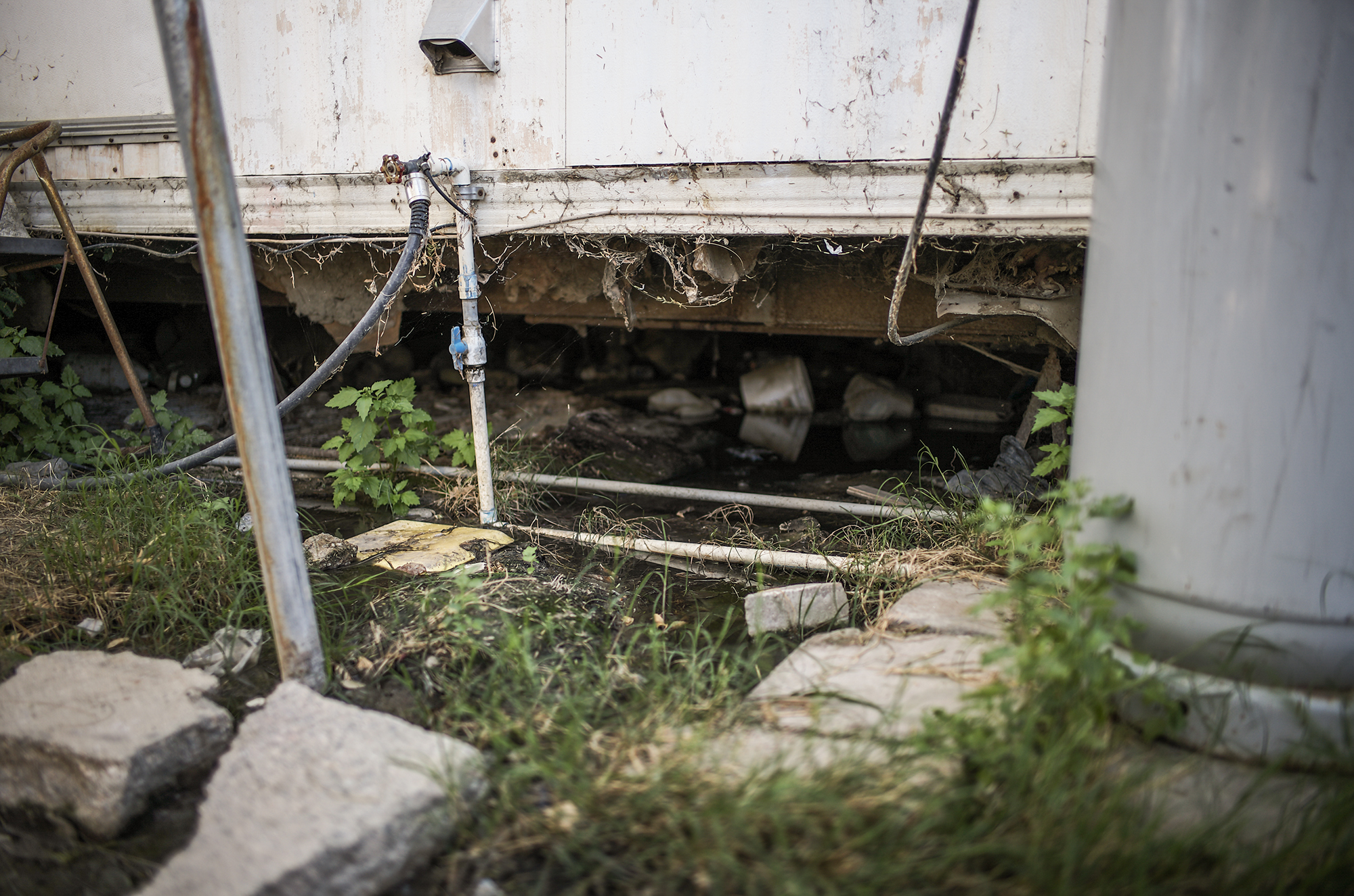 Sewage seeps from underneath a mobile home where Guillermina Zamudio, 44, lives with her family in the Shady Lane Estates mobile home park in Thermal, March 23, 2023.