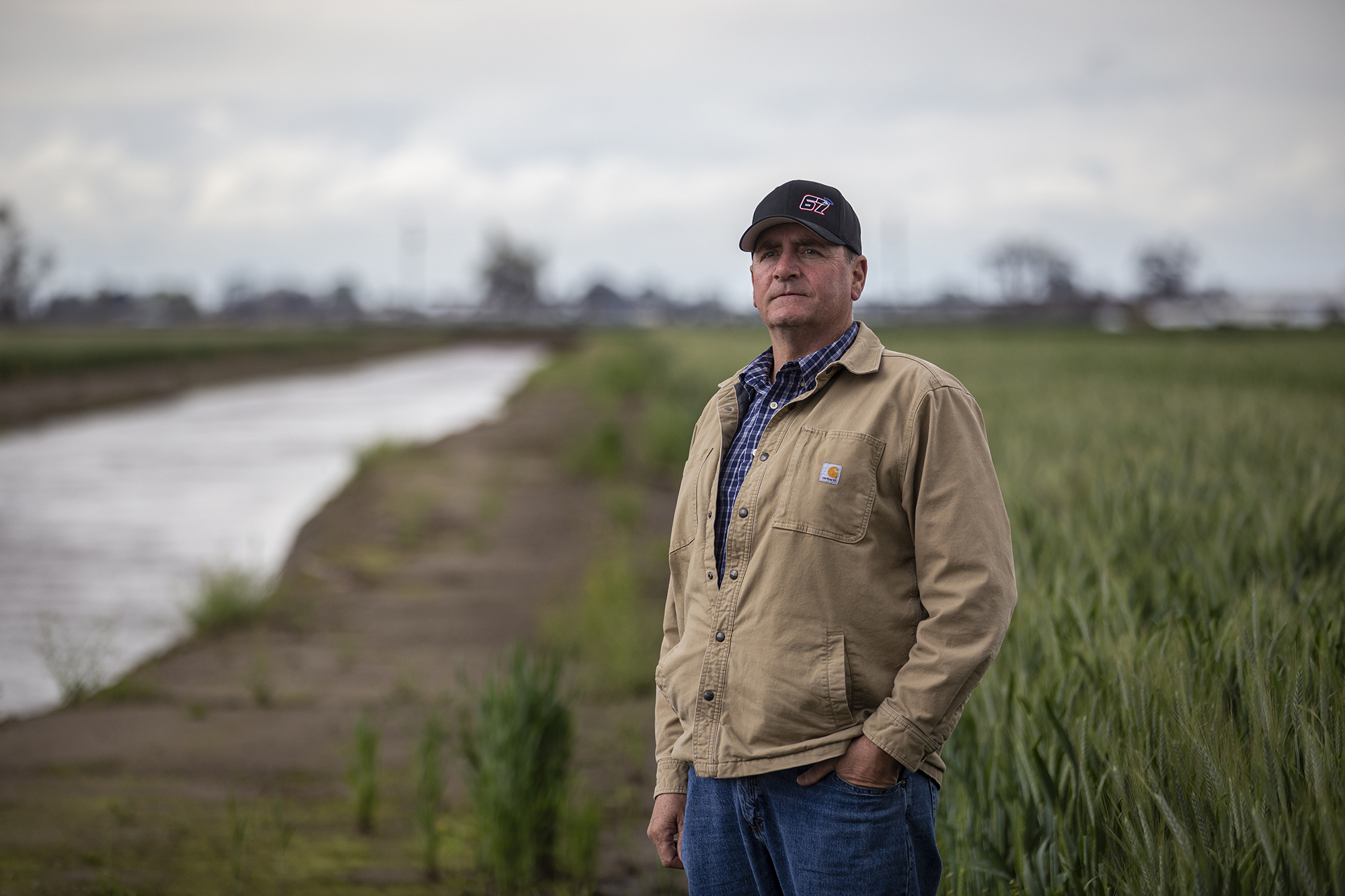 Stephen Mancebo stands near a canal by his farmland in Tulare County on March 23, 2023. 