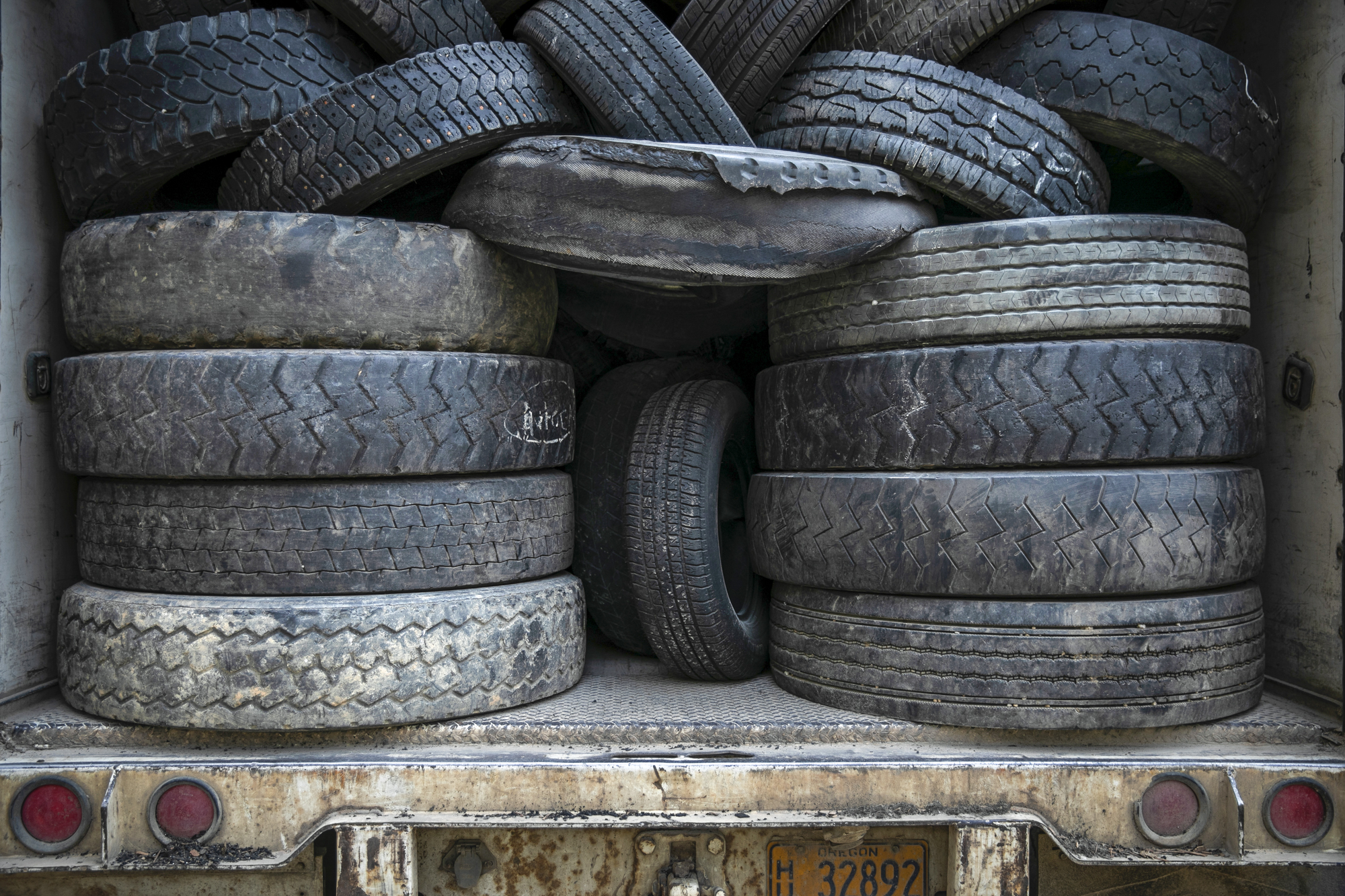 Tires, which are used as an alternative to traditional fossil fuels, are stacked in the back of trucks delivering them to the Martin Marietta Redding Cement Plant in Redding on June 7, 2022. Photo by Martin do Nascimento, CalMatters