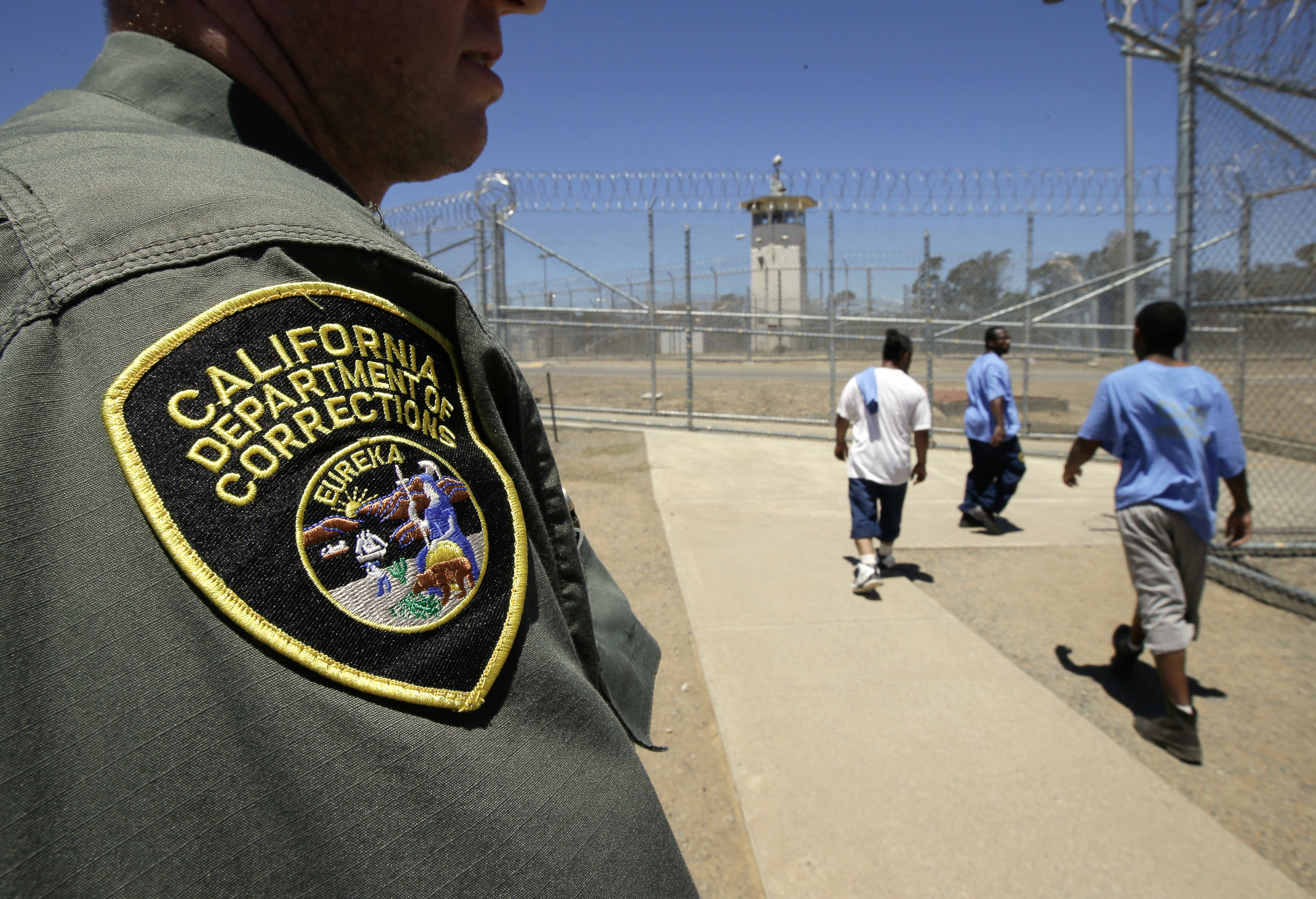 Inmates pass a correctional officer as they leave an exercise yard at the California Medical Facility in Vacaville on June 20, 2018. Photo by Rich Pedroncelli, AP Photo