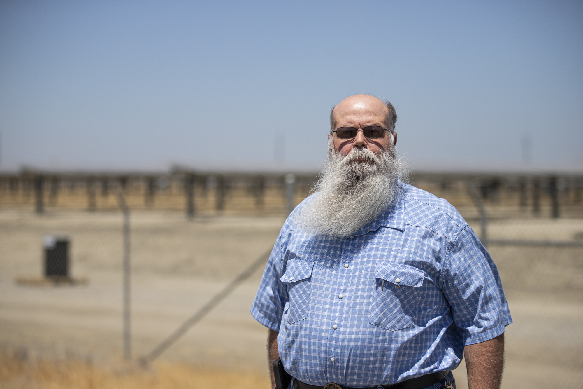 Kings County District 1 Supervisor Joe Neves poses for a photo in front of Kettleman City Power solar farm.