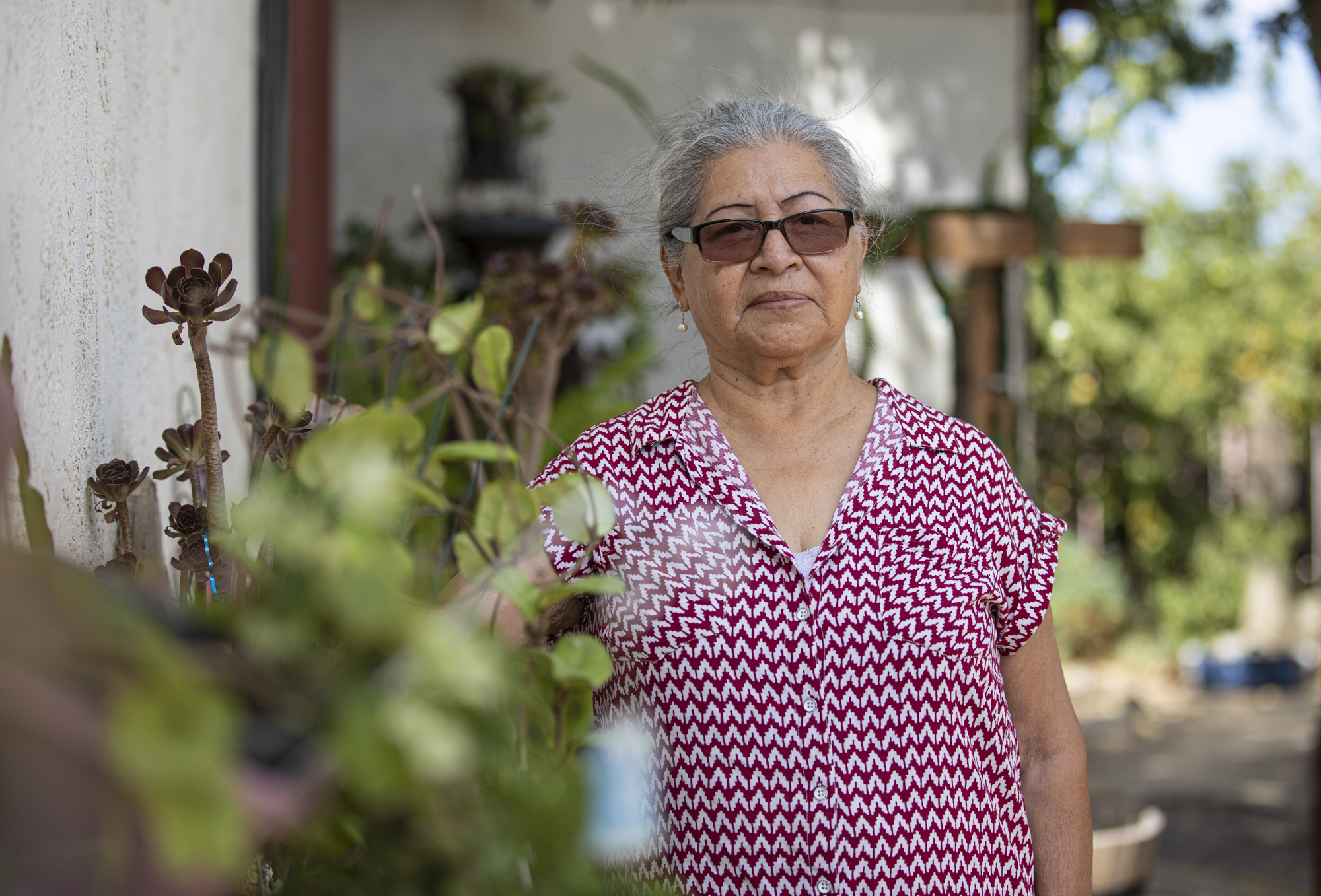 María Dolores Díaz poses for a photo in her backyard in Cantua Creek on Aug. 8, 2022. Photo by Larry Valenzuela, CalMatters/CatchLight Local