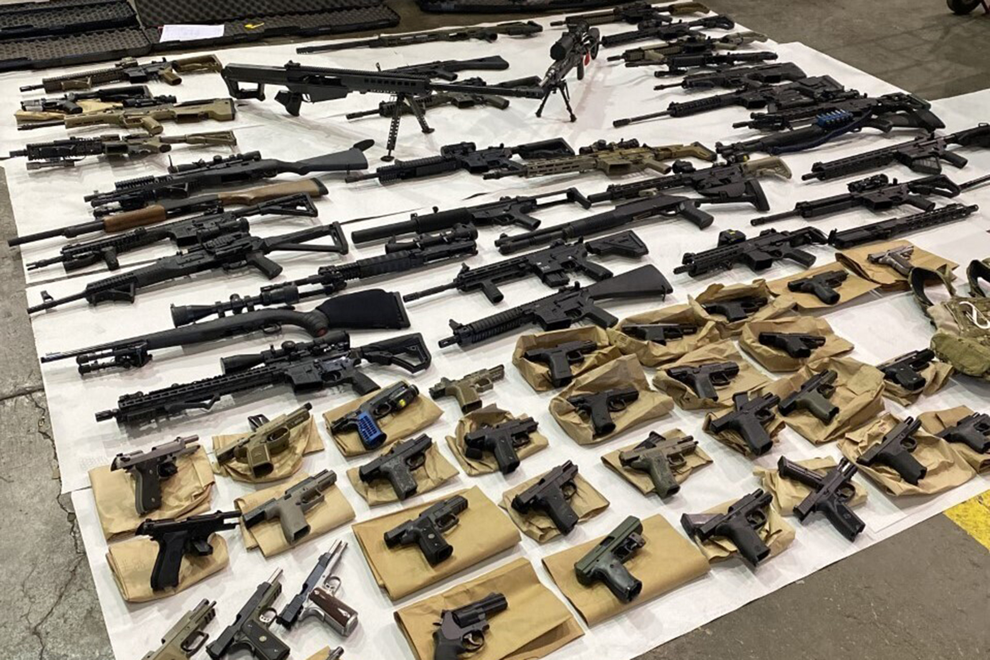Assault weapons, multiple high-capacity magazines, pistols, and other weapons seized from the home of homicide suspect Vu Thai