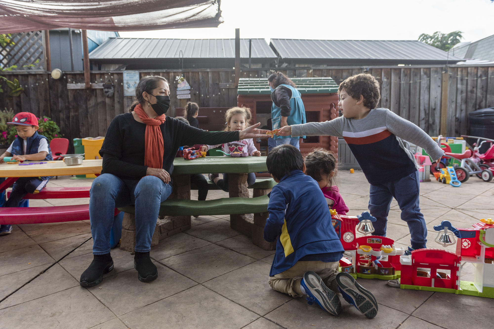 Patricia Moran plays with the children enrolled in her at-home daycare in San Jose on Nov. 2, 2022. Photo by Laure Andrillon for CalMatters