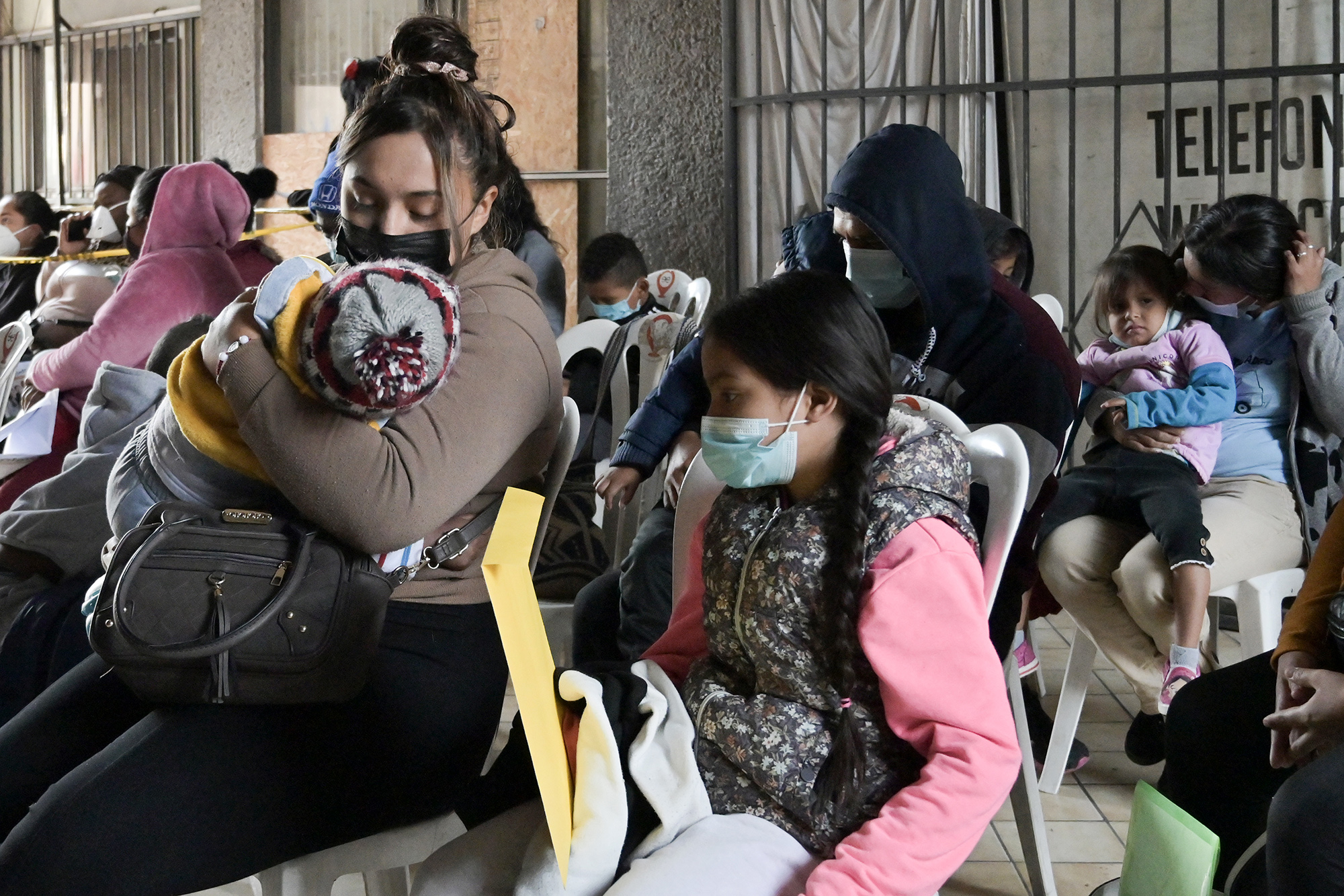 Migrants line up to get health services near the free non-profit clinic in Tijuana, Mexico, on Dec. 22, 2022.