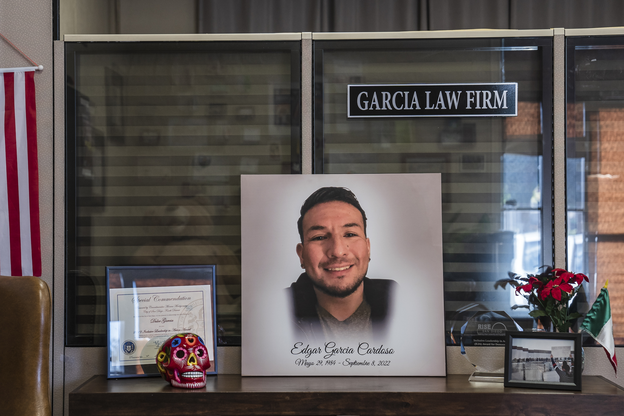 A photo of Edgar Saul Garcia Cardoso sits on a bookshelf in his sister Dulce Garcia's office in San Diego on Dec. 28, 2022.
