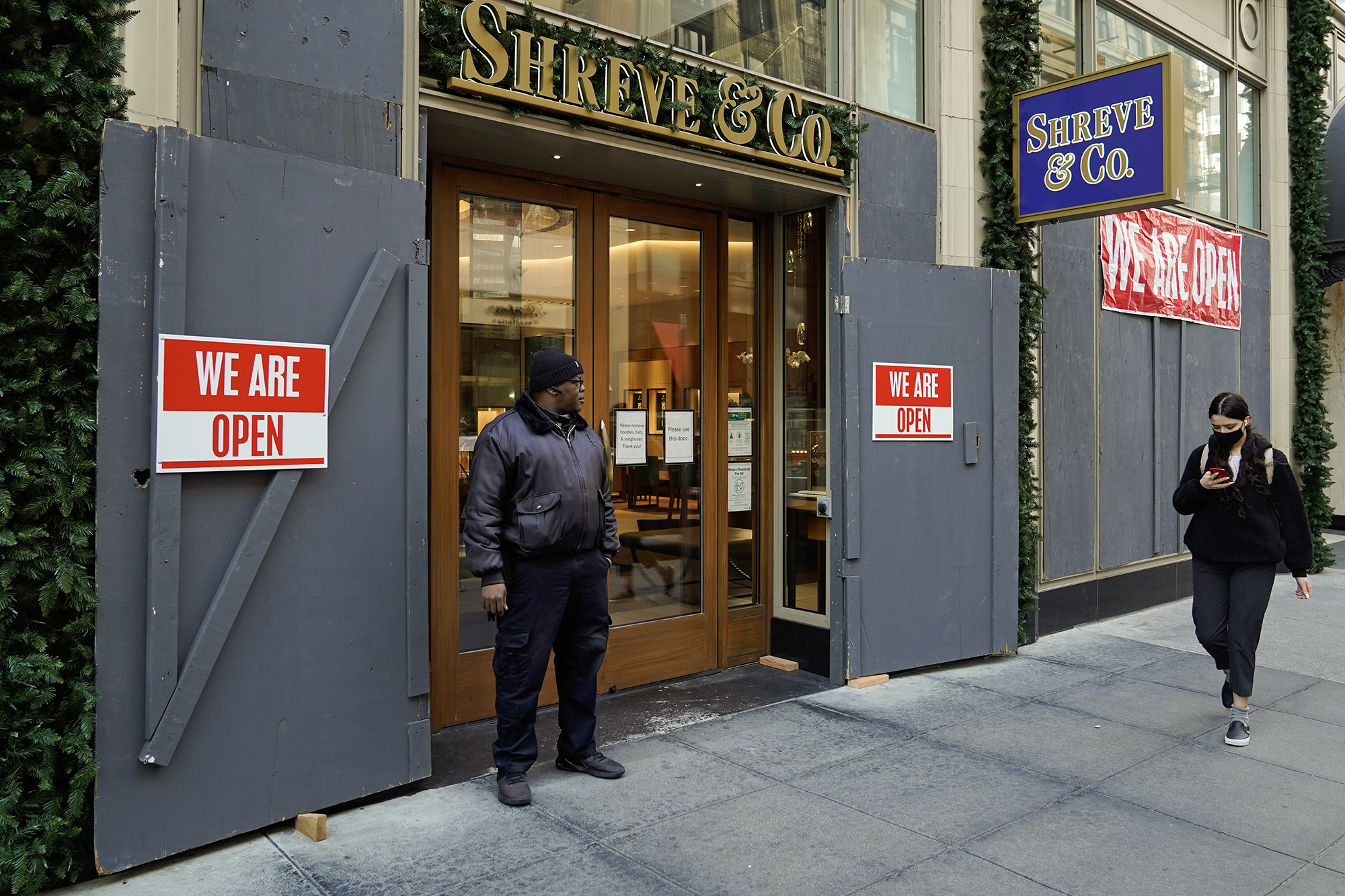 A security guard stands outside the heavily boarded Shreve & Co. jewelry store in San Francisco on Dec. 2, 2021. Photo by Eric Risberg, AP Photo