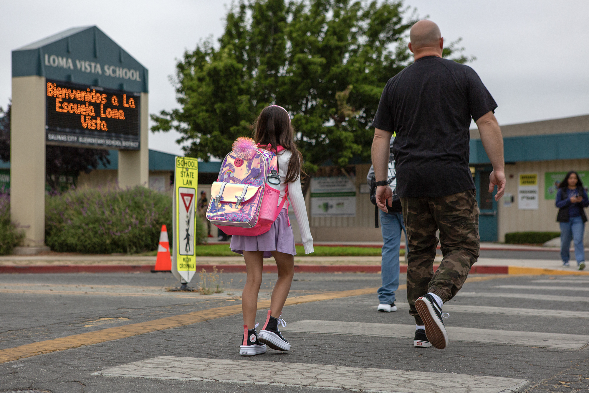Parents walk their kids to school on the first day of classes at Loma Vista Elementary School in Salinas on Aug. 8, 2023. Photo by Semantha Norris, CalMatters